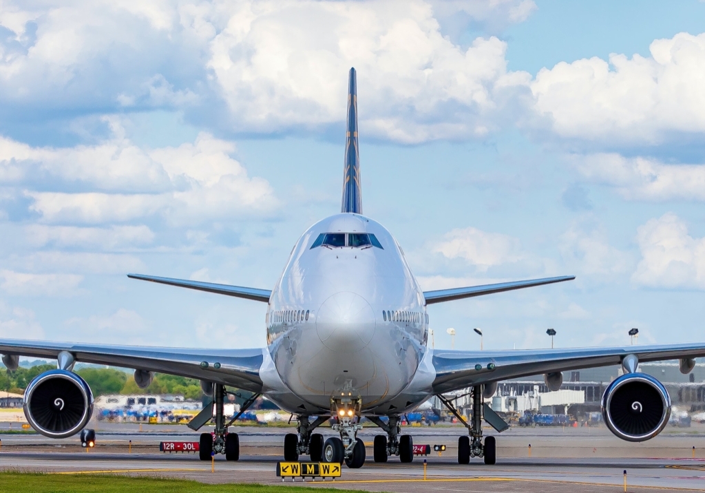 Large plane resting on the tarmac.