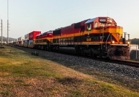 Freight train chugging along on a sunny afternoon.